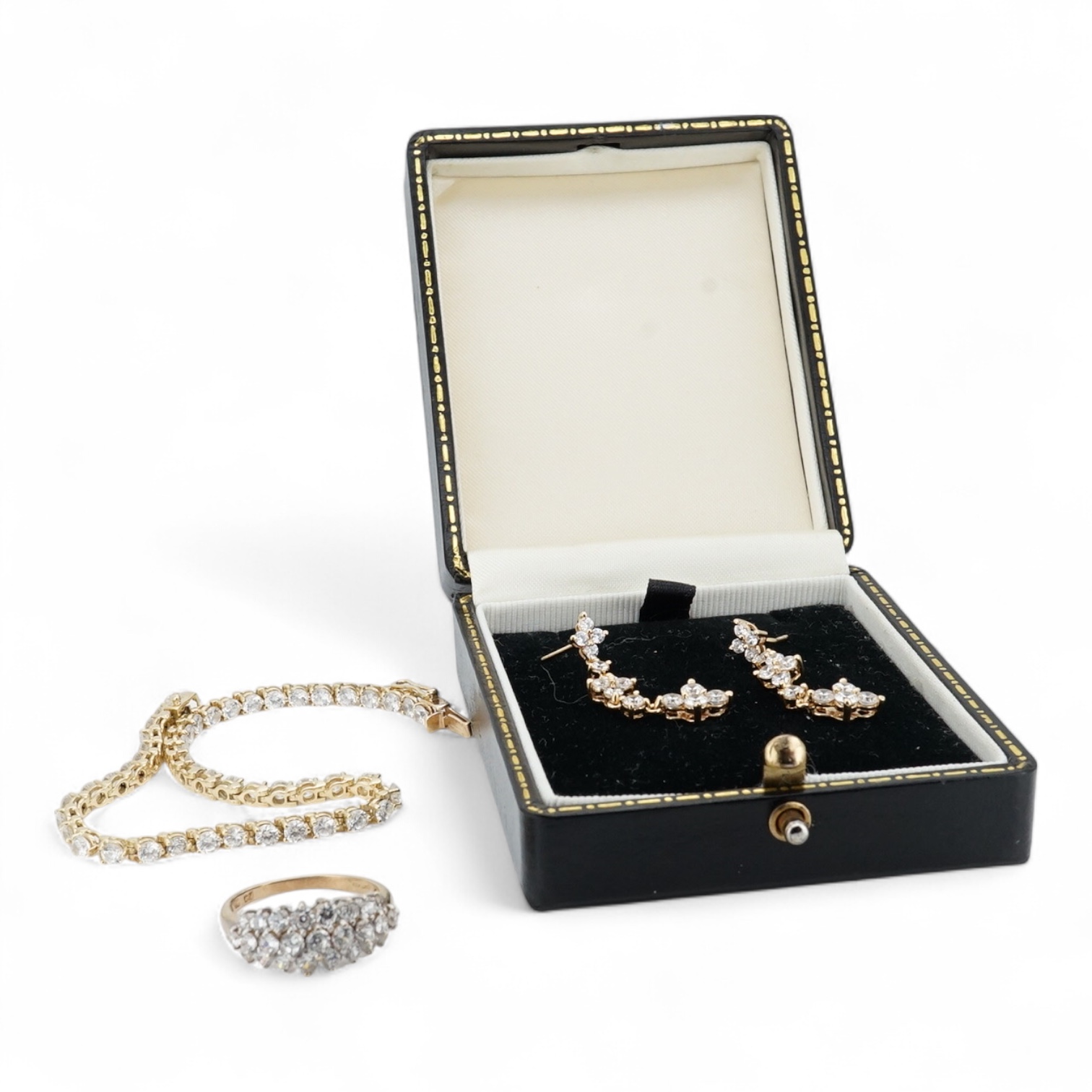A modern yellow metal (stamped 585) and cubic zirconia set line bracelet, 18cm and a pair of similar drop earrings, together with a similar 9k and cubic zirconia set cluster ring, size N.